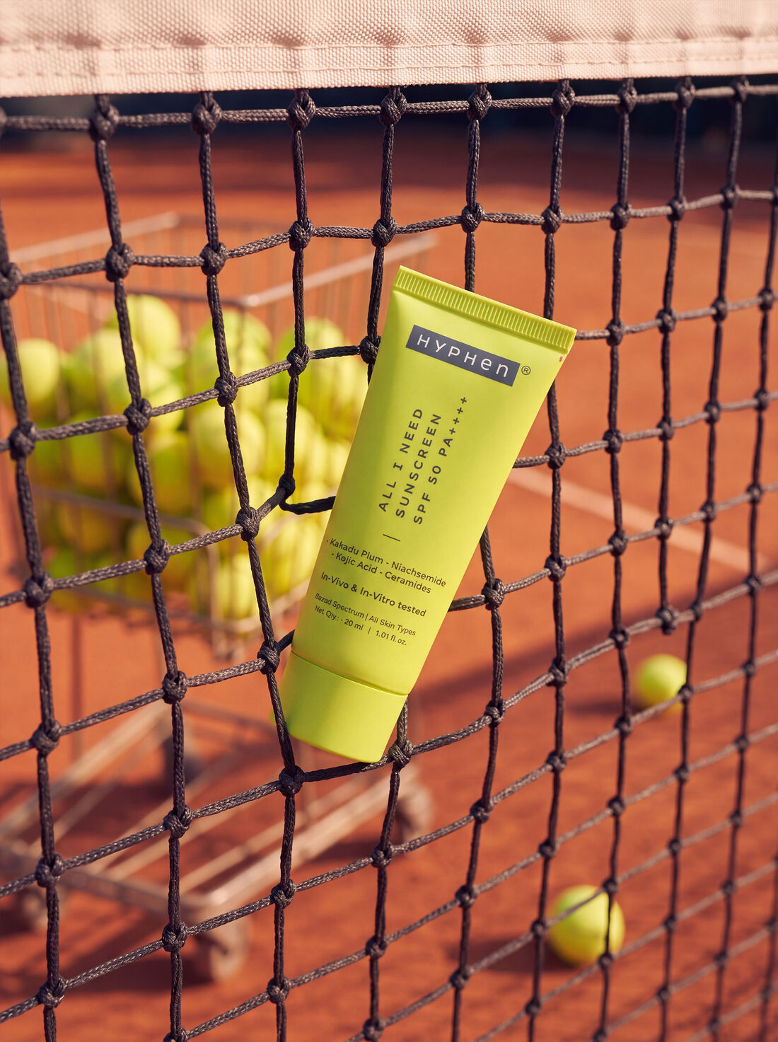 HYPHeN tube nestled in the strings of a tennis net